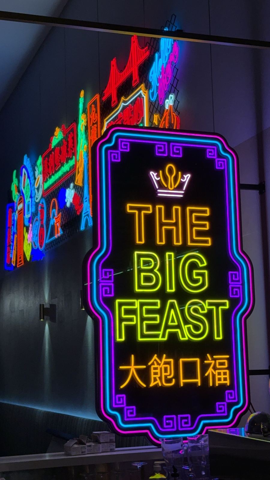 The Big Feast neon signage inside the restaurant
