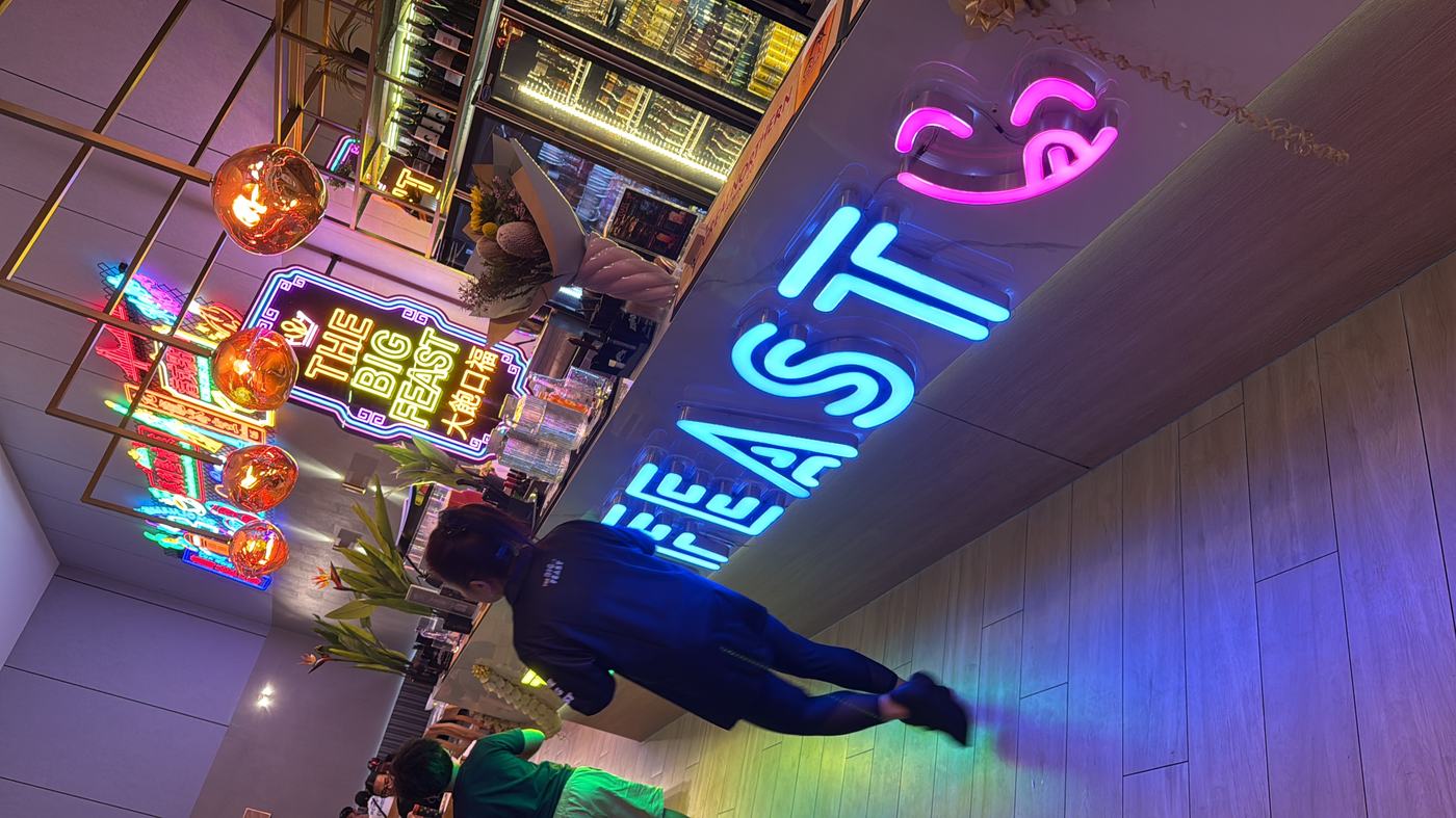 Reception counter with neon Big Feast letters